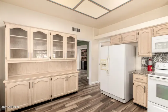 a kitchen with stainless steel appliances a refrigerator and cabinets