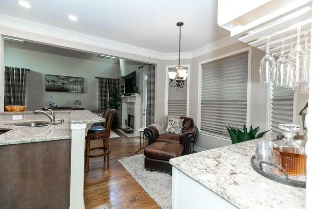 a kitchen with sink refrigerator and large window