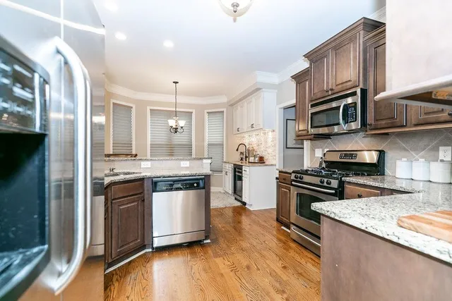 a kitchen with stainless steel appliances granite countertop a stove and a sink