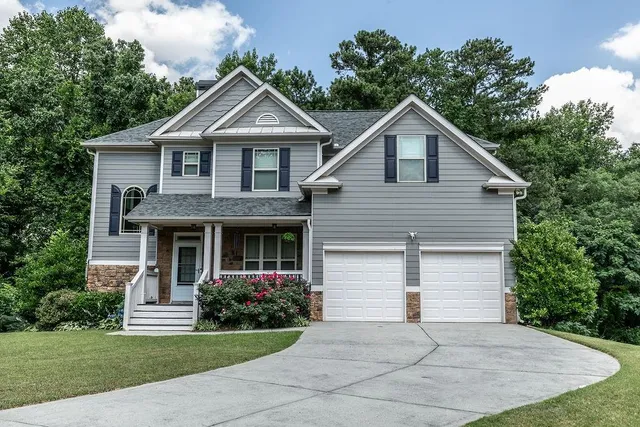 a front view of house with yard and green space