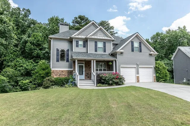a front view of a house with a yard and garage
