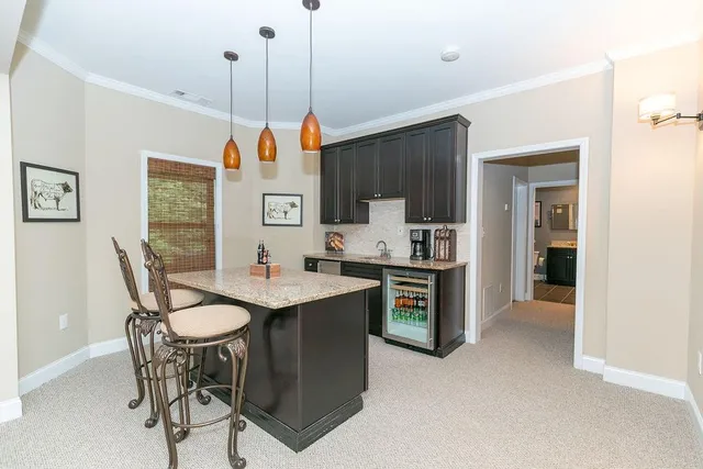 a dining room with a sink a counter space a dining table and chairs