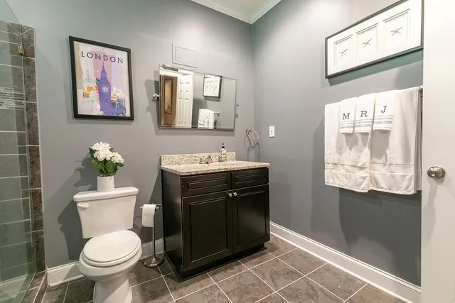 a bathroom with a toilet a sink and mirror