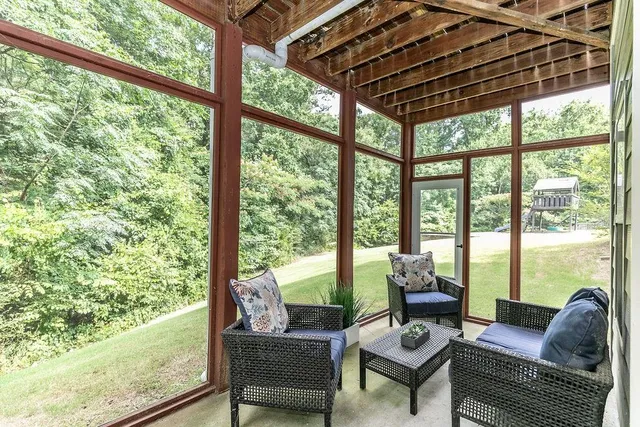 a living room with furniture and floor to ceiling windows