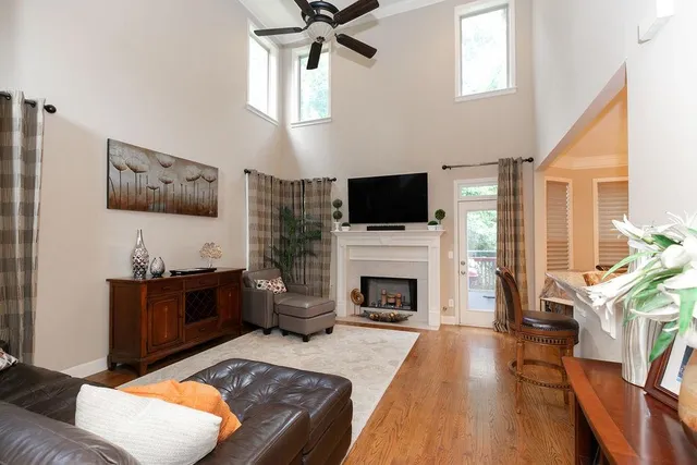 a living room with furniture a fireplace and a flat screen tv