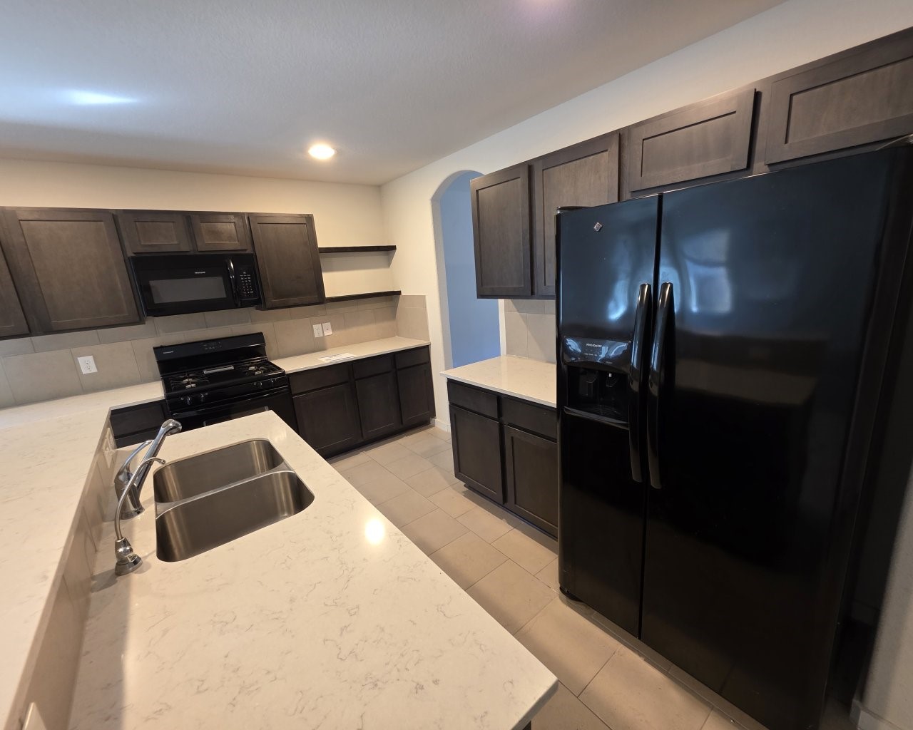 6807 Bardsdale Court Rosharon, TX 77583 - Photo 2 of 20 a kitchen with a refrigerator sink and stove