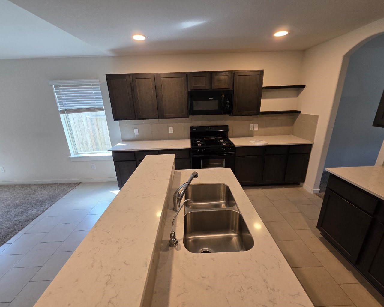 6807 Bardsdale Court Rosharon, TX 77583 - Photo 3 of 20 a kitchen with a sink a microwave a stove and refrigerator