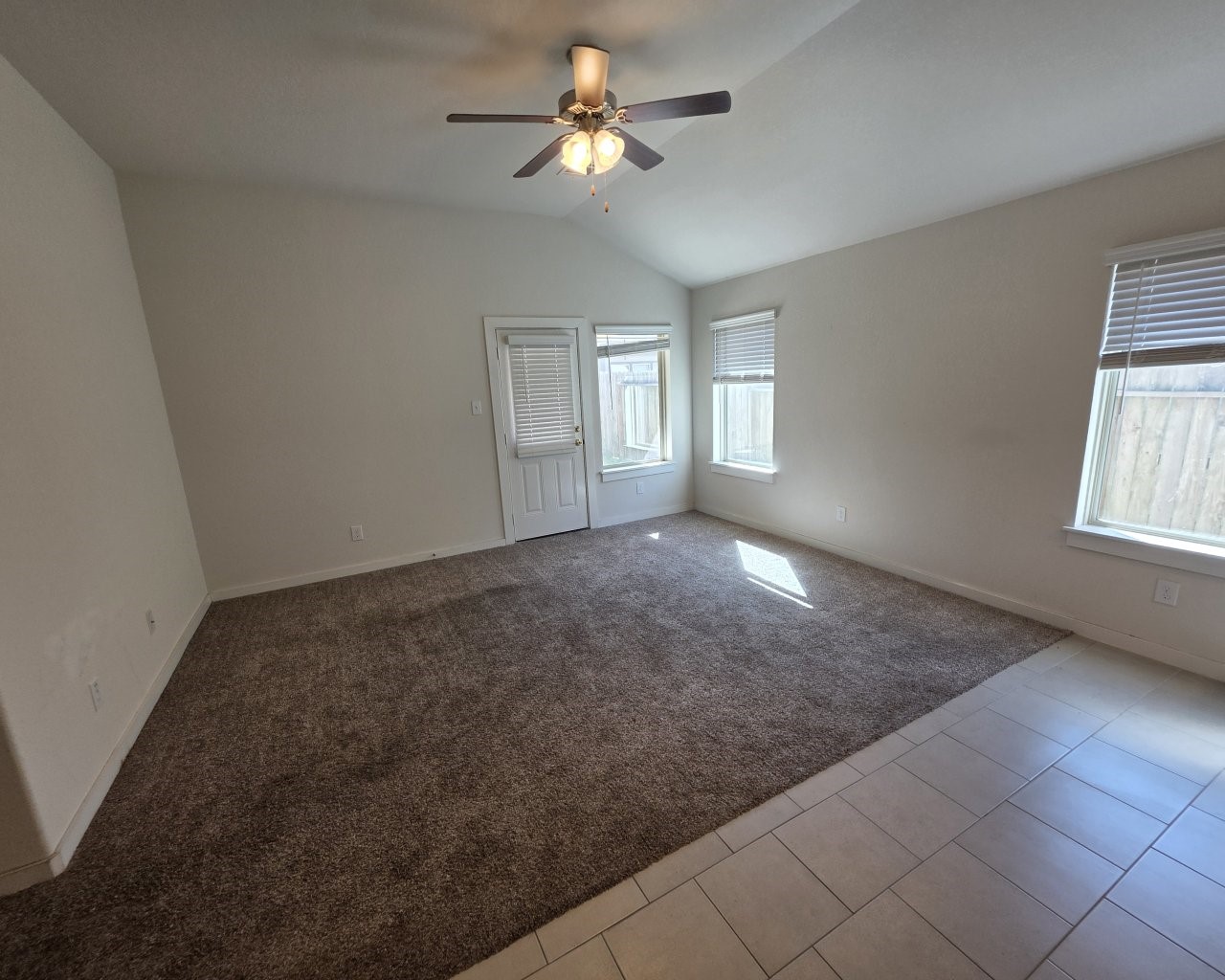6807 Bardsdale Court Rosharon, TX 77583 - Photo 6 of 20 an empty room with windows and chandelier fan