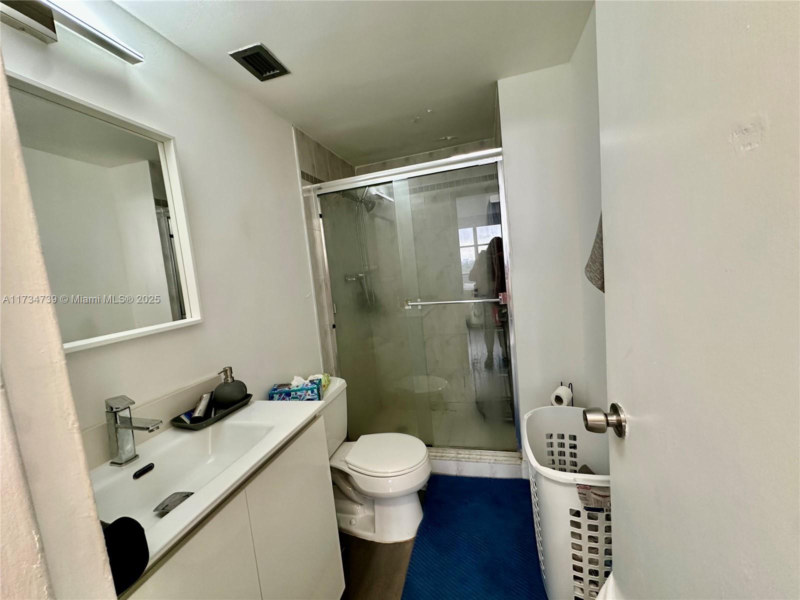 7441 Wayne Avenue, Unit 6B Miami Beach, FL 33141 - Photo 12 of 33 a bathroom with a sink toilet and shower