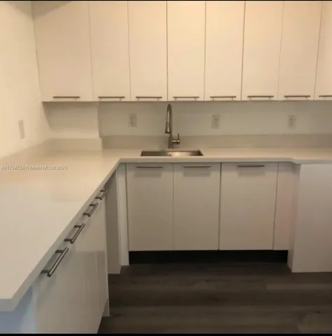 a view of a livingroom with furniture and refrigerator