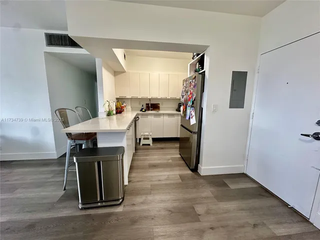 a bedroom with a bed and large windows