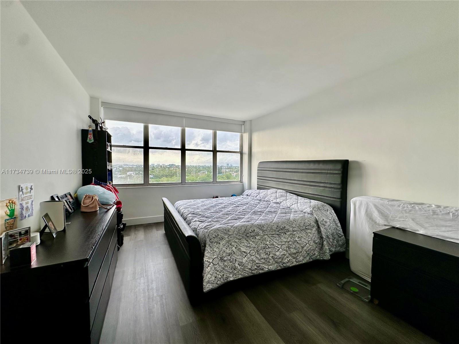 7441 Wayne Avenue, Unit 6B Miami Beach, FL 33141 - Photo 5 of 33 a bedroom with a bed and large windows