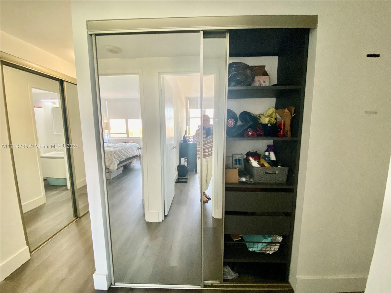 7441 Wayne Avenue, Unit 6B Miami Beach, FL 33141 - Photo 9 of 33 a bathroom with a glass shower door and a mirror