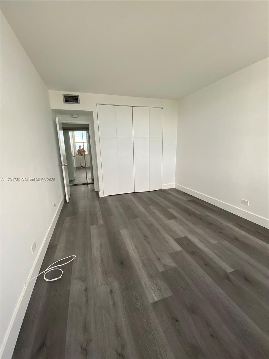 7441 Wayne Avenue, Unit 6B Miami Beach, FL 33141 - Photo 10 of 33 a view of a livingroom with wooden floor and a window
