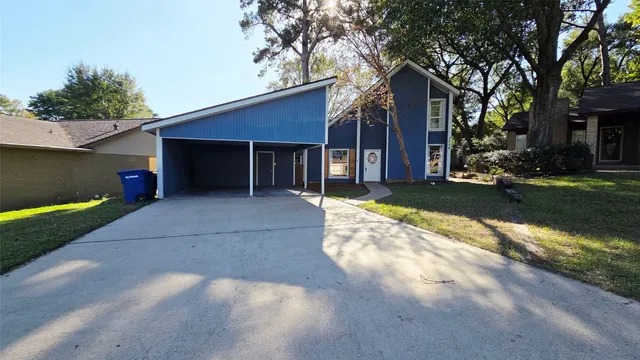 a view of a house with a yard and garage