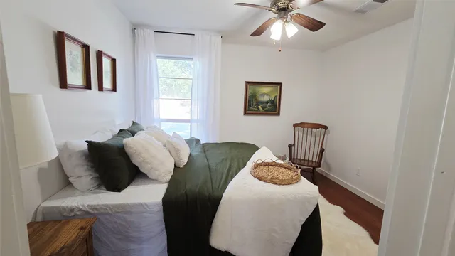 a bedroom with bed and a window