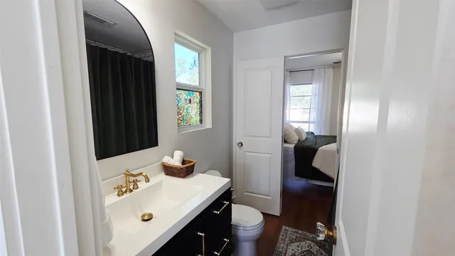 a bathroom with a sink vanity and a mirror