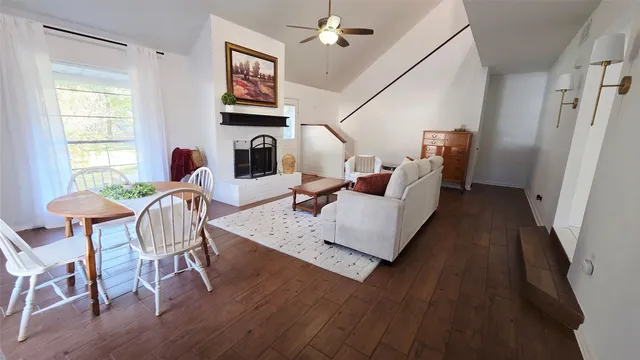 a living room with furniture fireplace and wooden floor