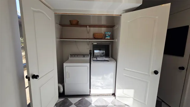 a utility room with cabinets washer and dryer