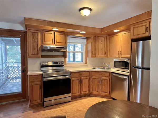 a kitchen with stainless steel appliances granite countertop a stove a refrigerator and a sink