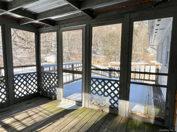 a view of a room with wooden floor