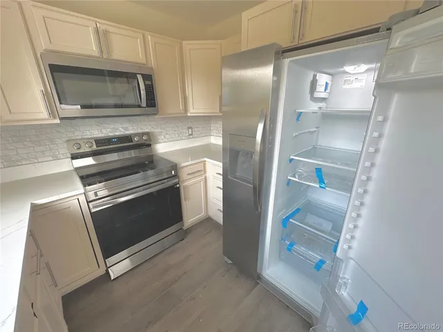 a kitchen with a refrigerator stove and microwave