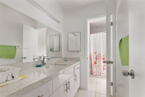 a bathroom with a double vanity sink mirror and next