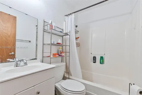 a bathroom with a sink toilet vanity and shower