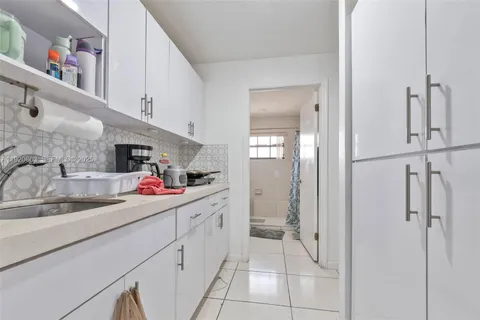 a kitchen with a sink and cabinets