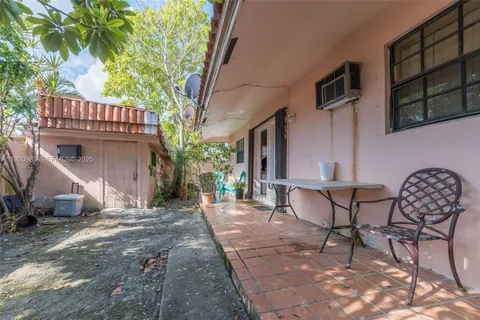 a view of a patio with table and chairs and potted plants