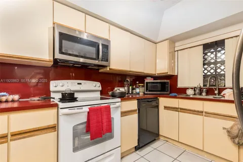 a kitchen with stainless steel appliances granite countertop a stove top oven