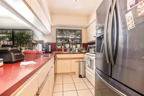 a kitchen with stainless steel appliances a refrigerator sink and cabinets