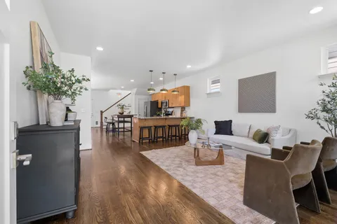 a living room with furniture and a wooden floor