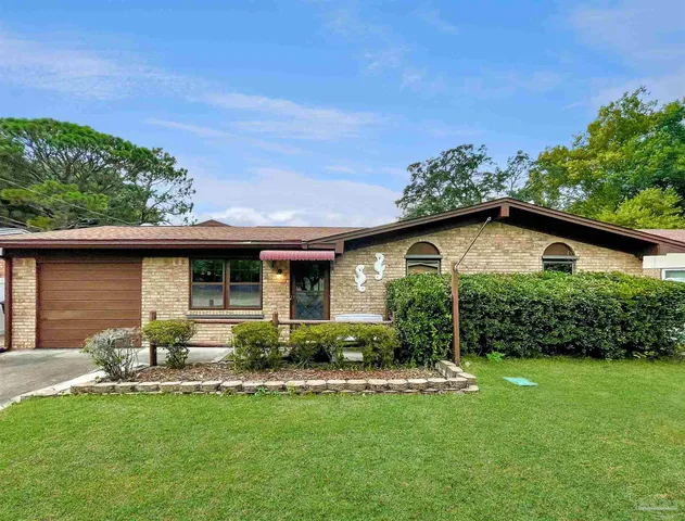 a front view of house with yard and outdoor seating