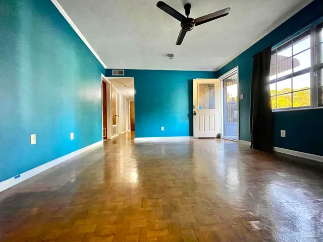 a large white kitchen with a window and refrigerator