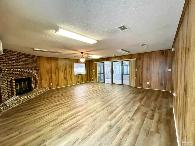 a view of an empty room with a fireplace