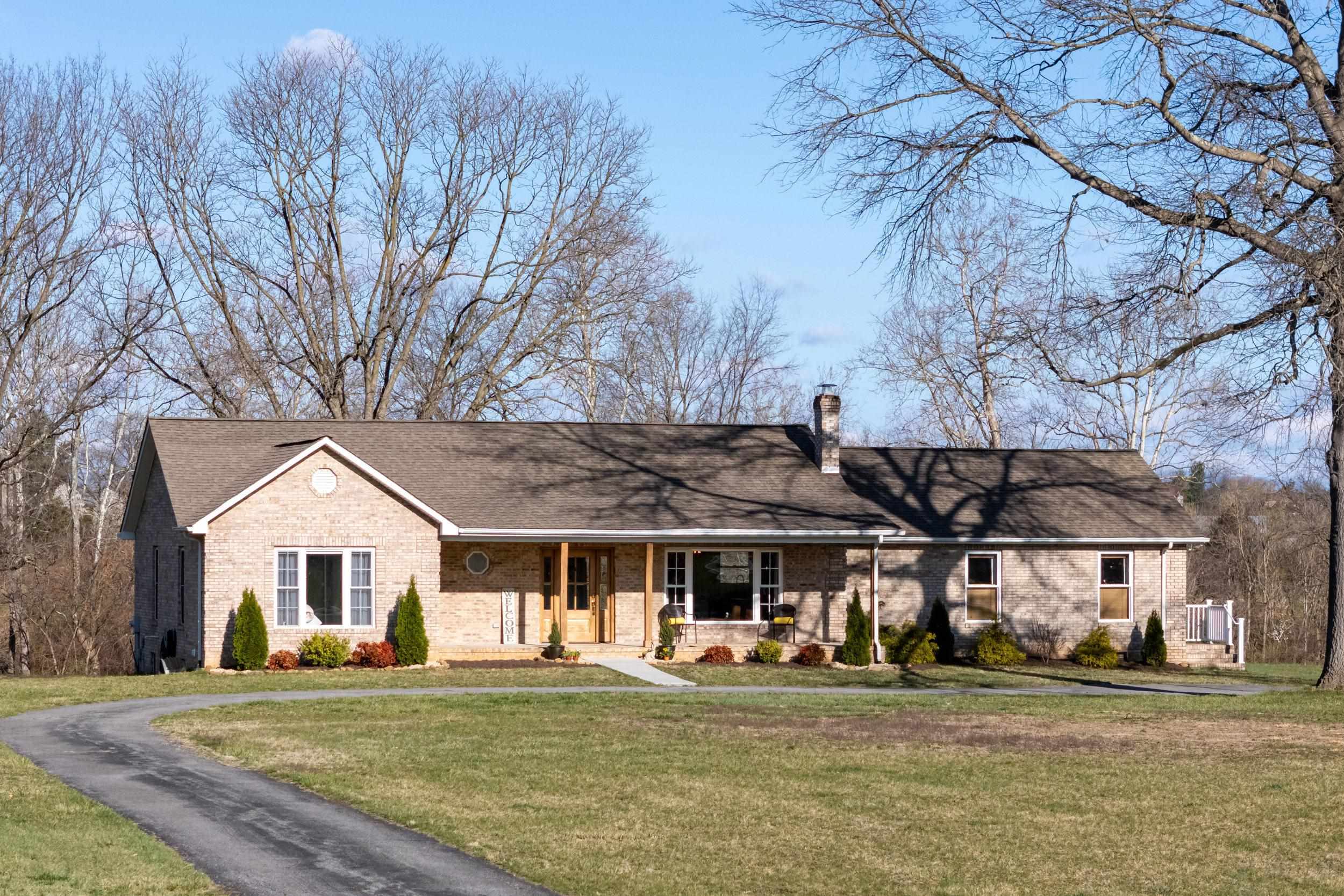 901 Riverside Avenue Grottoes, VA 24441 - Photo 1 of 75 a front view of a house with a garden and trees
