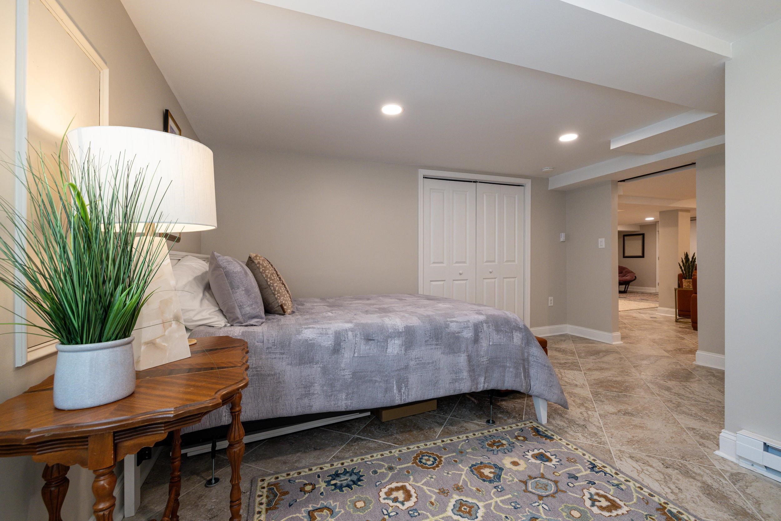 901 Riverside Avenue Grottoes, VA 24441 - Photo 62 of 75 a bedroom with a bed and a potted plant