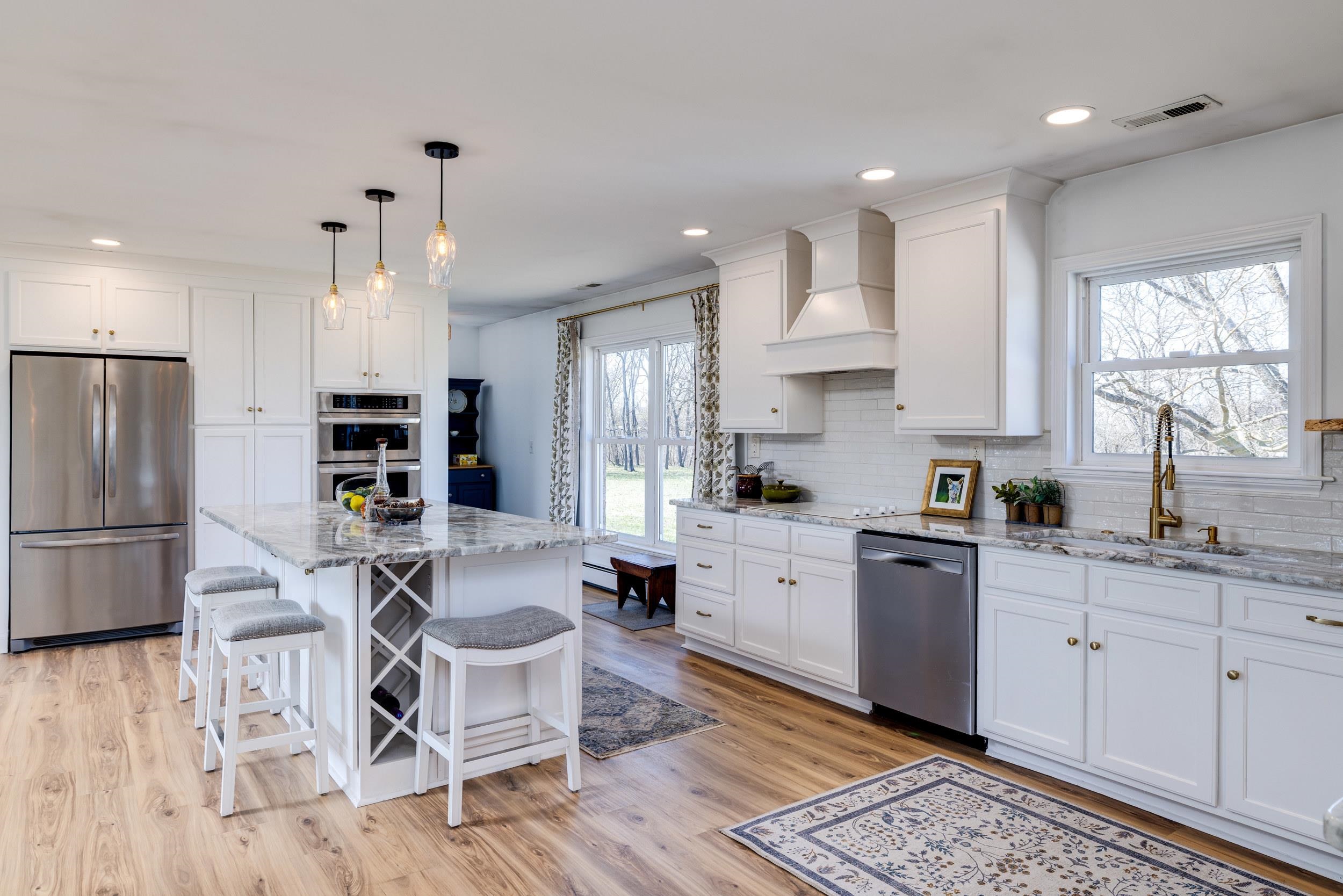 901 Riverside Avenue Grottoes, VA 24441 - Photo 9 of 75 a kitchen with stainless steel appliances kitchen island granite countertop a refrigerator oven a sink dishwasher and white cabinets with wooden floor