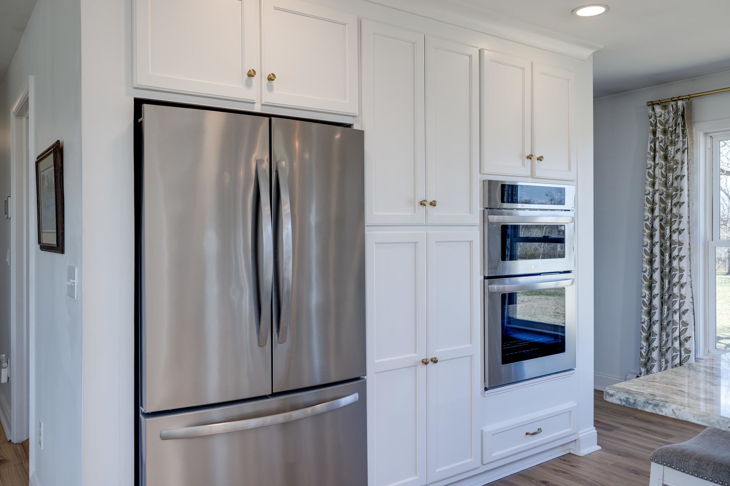 901 Riverside Avenue Grottoes, VA 24441 - Photo 10 of 75 a white refrigerator freezer and a stove sitting inside of a kitchen