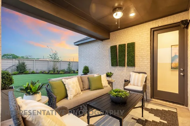 a living room with furniture and potted plants