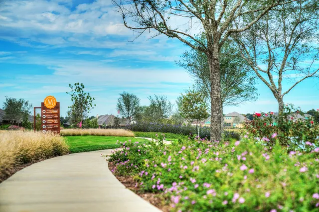 a view of a house with a yard and wooden fence