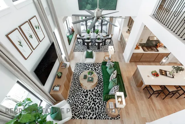 a living room with furniture potted plant and a flat screen tv