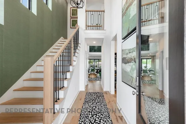 a dining room with furniture a rug and a floor to ceiling window