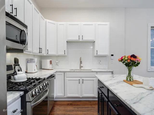 a kitchen with a sink stove and cabinets