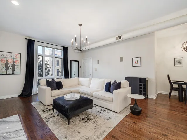 a living room with furniture or couch and a wooden floor