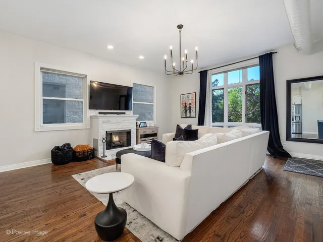 a living room with fireplace furniture and a flat screen tv