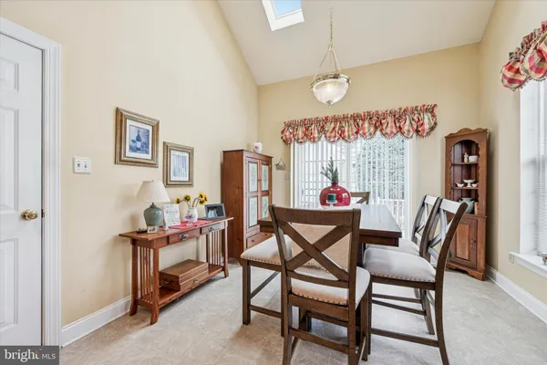 a dining room with furniture and a chandelier
