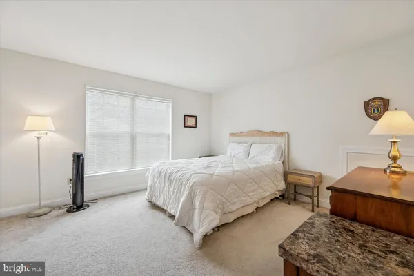 a bedroom with a bed and a lamp on table