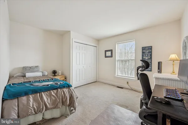 a bedroom with a bed a desk and chair